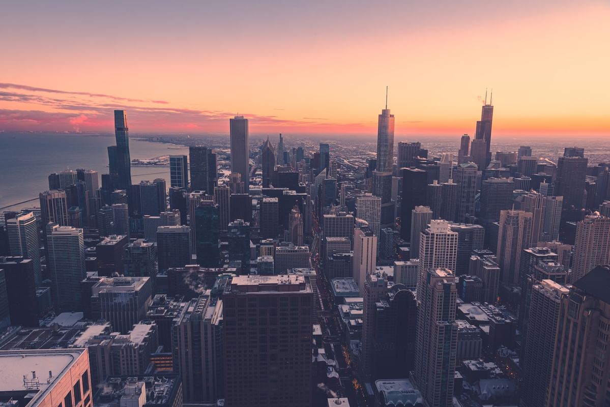 Panoramic view of Chicago skyline at sunset with towering skyscrapers and vibrant sky near Warwick Allerton Chicago