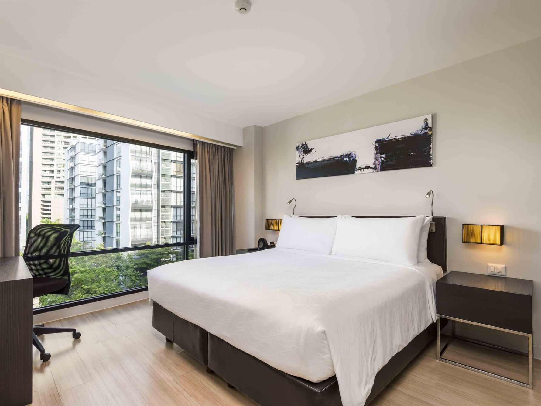 Bed in One-Bedroom Grand Deluxe at Maitria Hotel Sukhumvit 18
