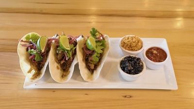 carnitas tacos with beans, salsa, and rice
