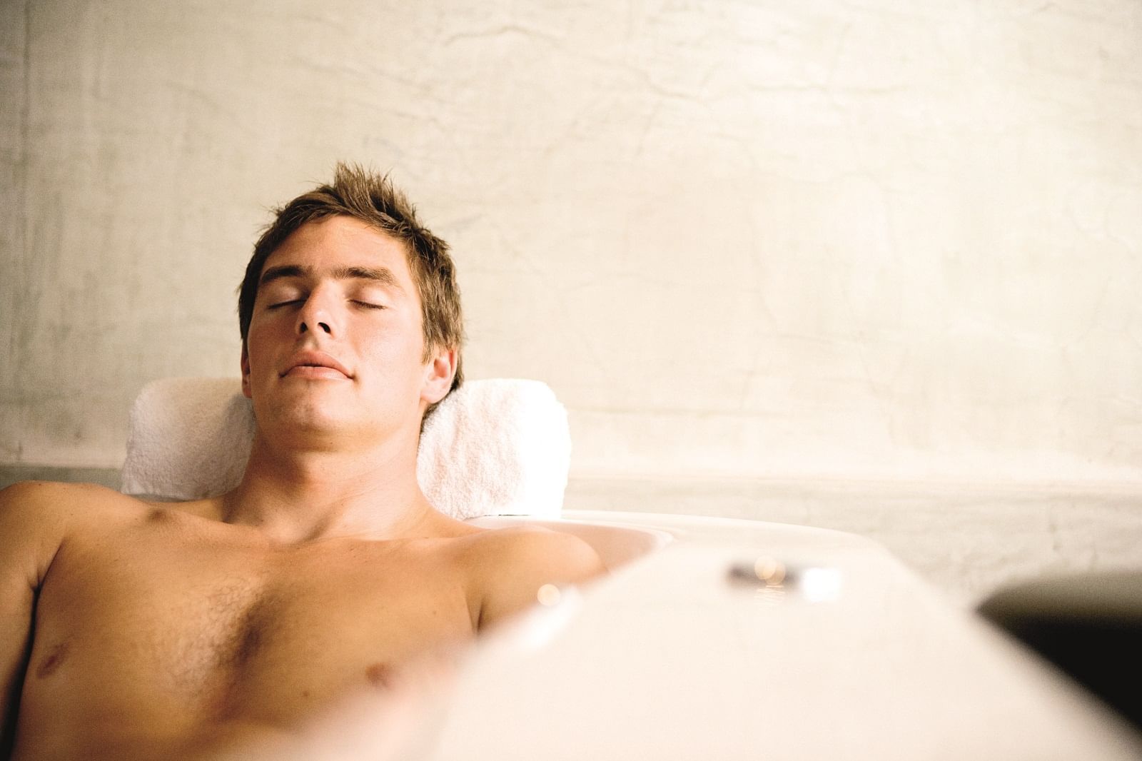 Boy relaxing in a bathtub at Novotel Barossa Valley