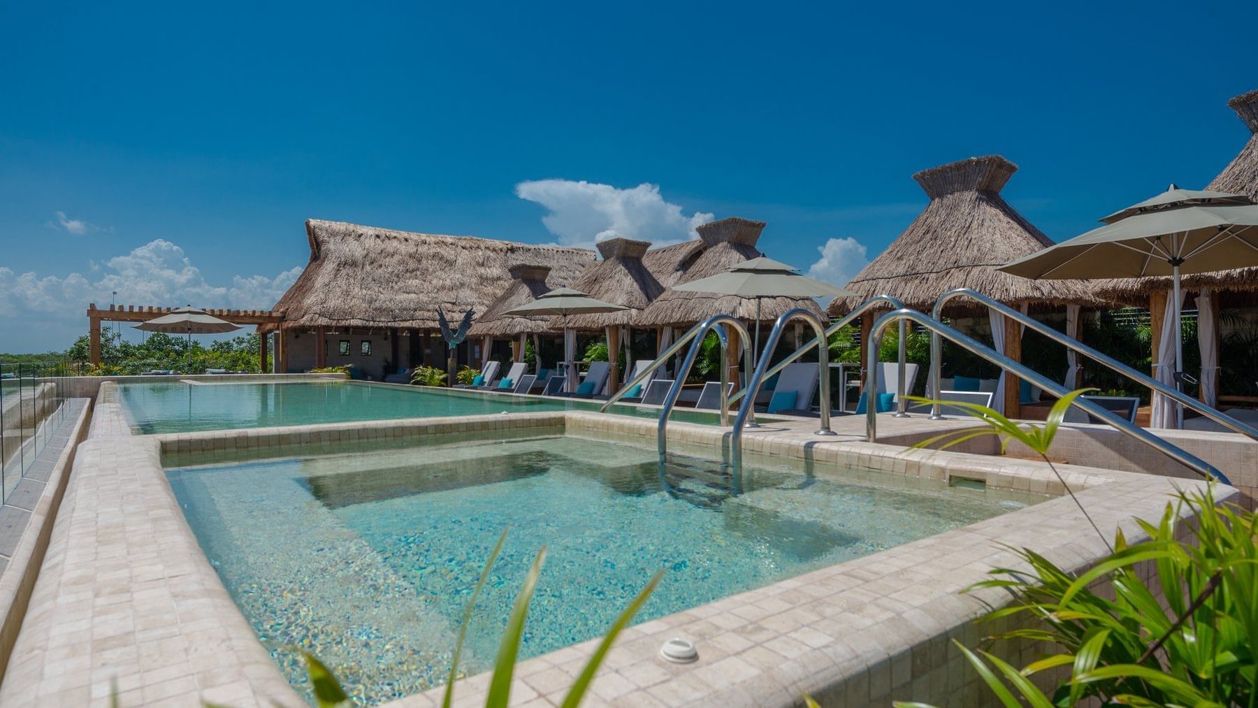 Outdoor pool with hammocks at  Naay Tulum Curamoria Collection