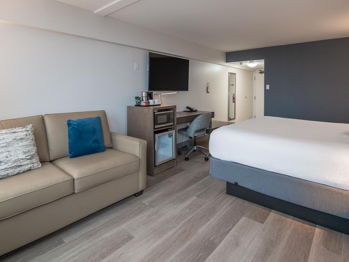 Room with sofa and bed at Coast Bastion Hotel in Nanaimo.