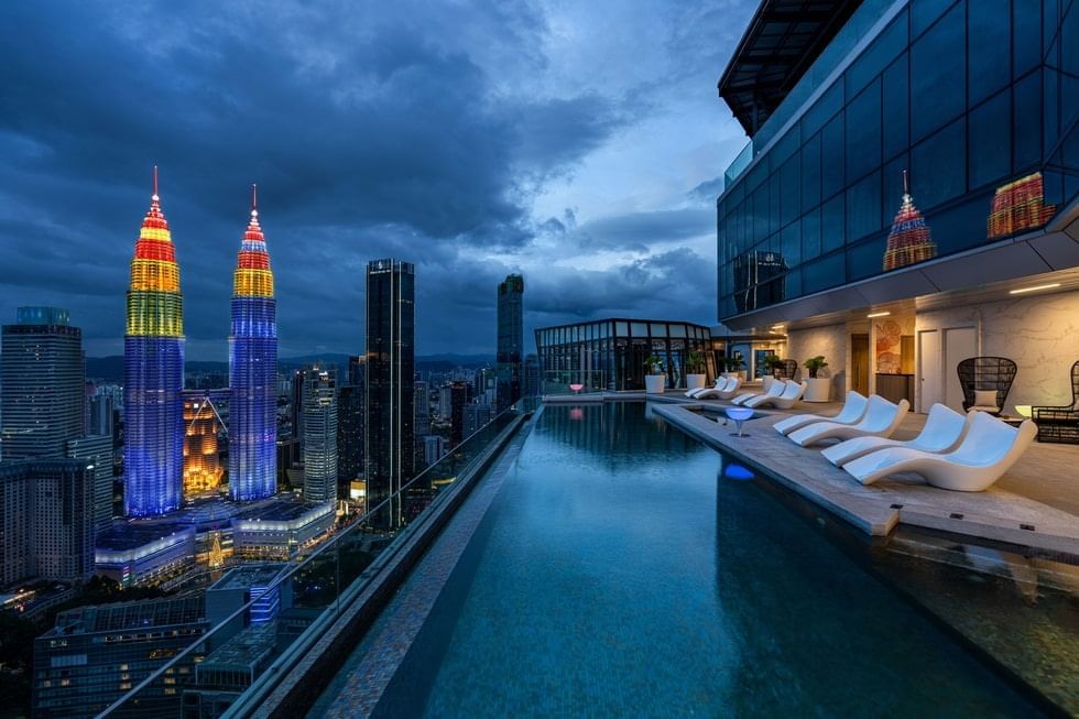 Balcony pool with loungers and city view at Imperial Lexis Kuala Lumpur