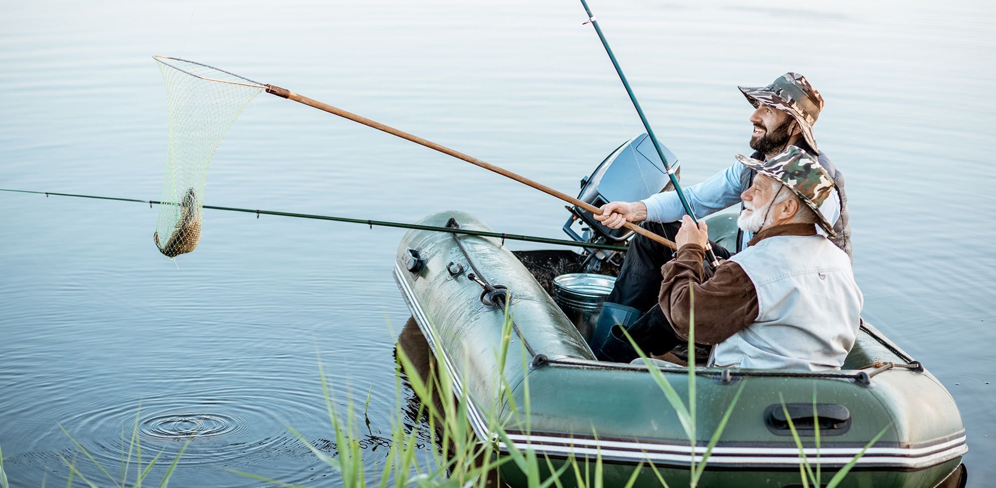 2 men fishing in float tube at the lake near Coast Fort St.John