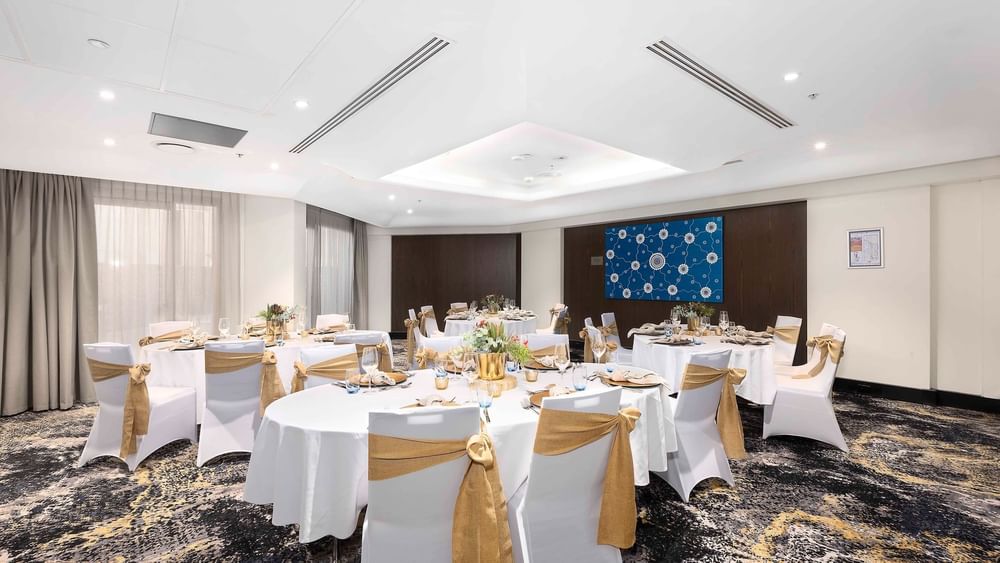 Set up banquets by the large windows with city views in The Yarra Room at Novotel Sydney on Darling Harbour