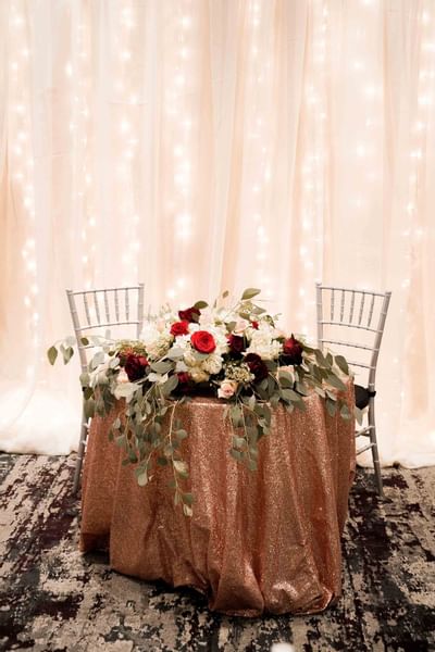 table with flower décor and two chairs