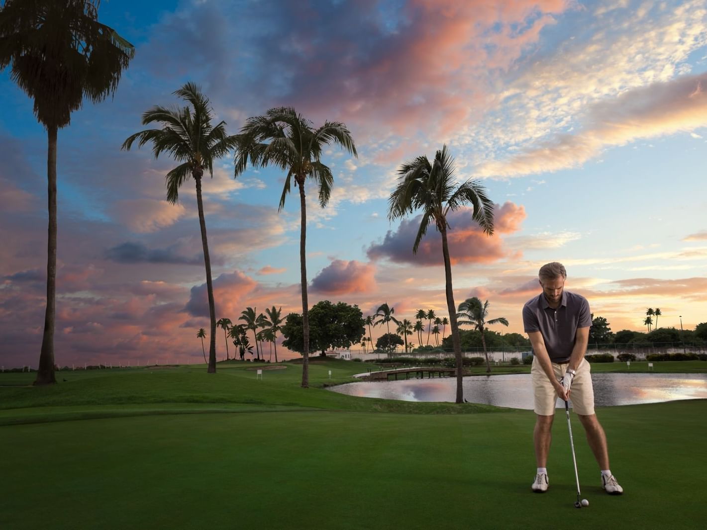 Man playing golf at dusk at the La Coleccion Resorts
