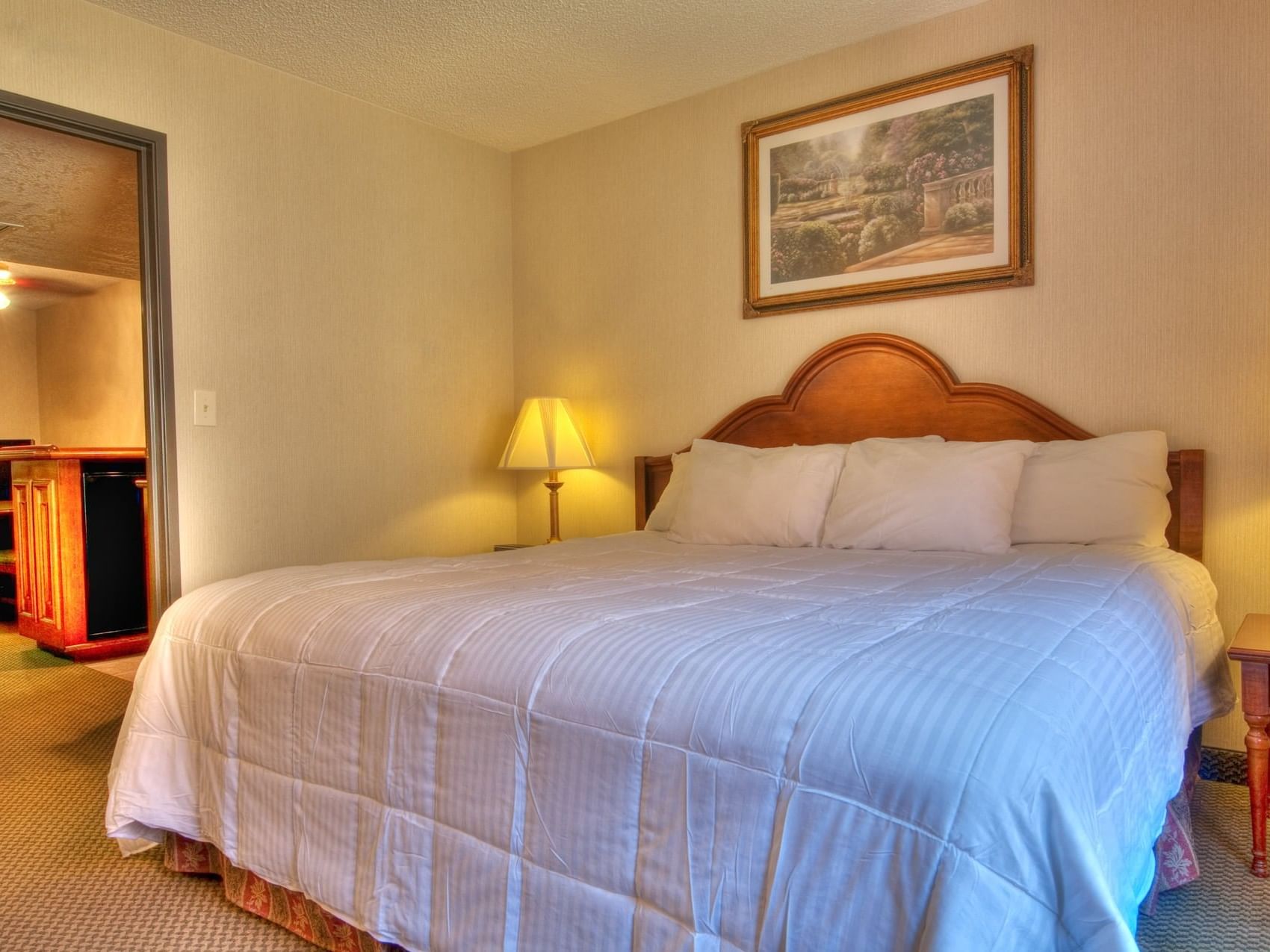 King bed in Abilene King Suite Bedroom at MCM Eleganté Suites