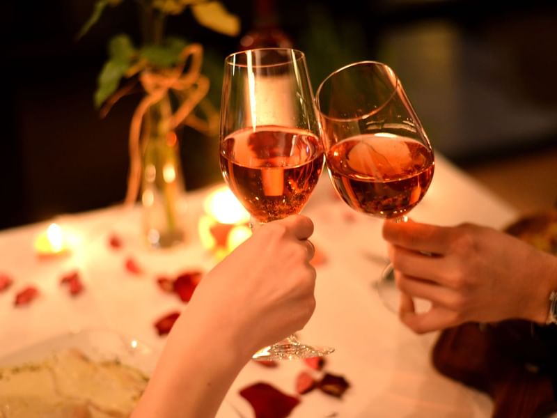 A couple toasting their glasses in a romantic dinner at Live Aqua Resorts and Residence Club