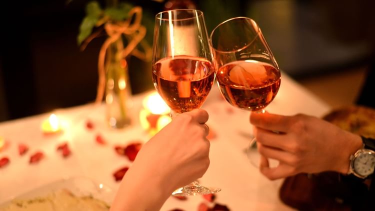 A couple celebrating with wine glasses at Grand Fiesta Americana Hotel and Resorts