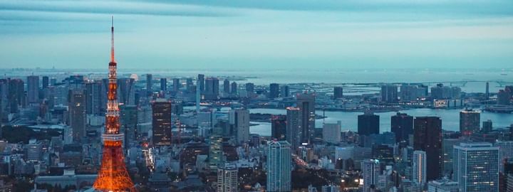 Iconic Tokyo Tower at night with city lights & the bay near Henn Na Hotel New York, a Midtown Manhattan hotel