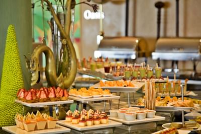 A lavish dessert buffet featuring colorful cakes and pastries in Oásis Terrasse Restaurant at Hotel Cascais Miragem