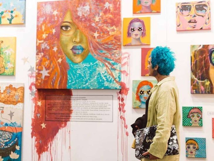 Man enjoying the exhibits at an Art exhibition near Fiesta Inn