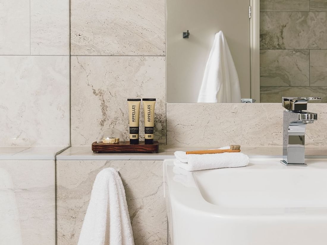 Bath amenities by the vanity in 1 Bedroom Deluxe Apartment at Quay West Suites Melbourne