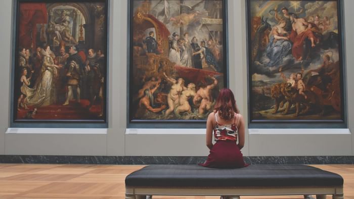 A lady seating at the museum near The Original Hotels