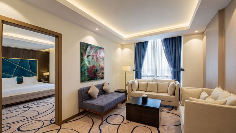 Lounge area with bedroom view in Junior Suite at Warwick Riyadh