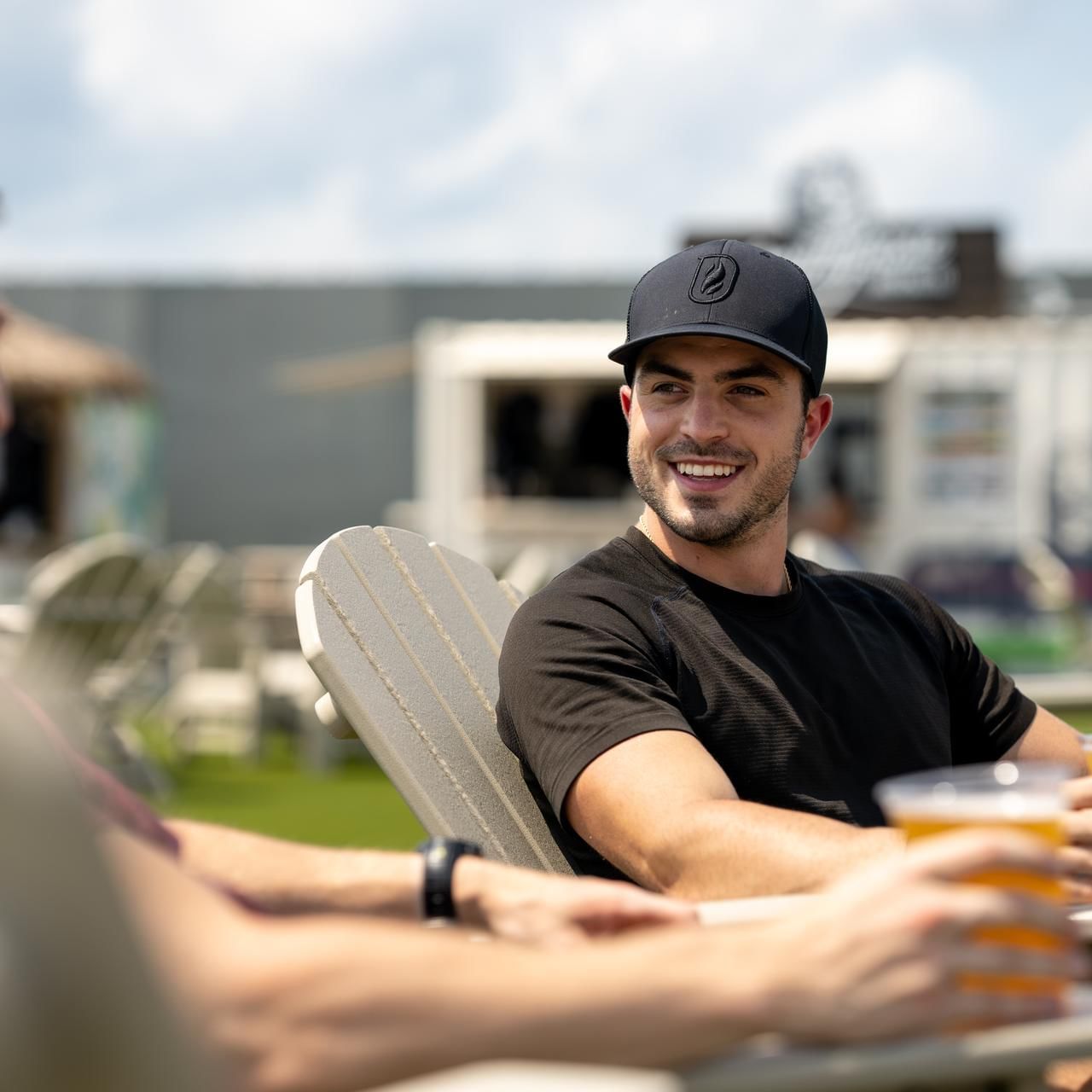 Men hanging out while having beer in Beer Garden at The Artisan Hotel at Tuscan Village