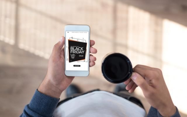 man browsing black friday deals on his mobile