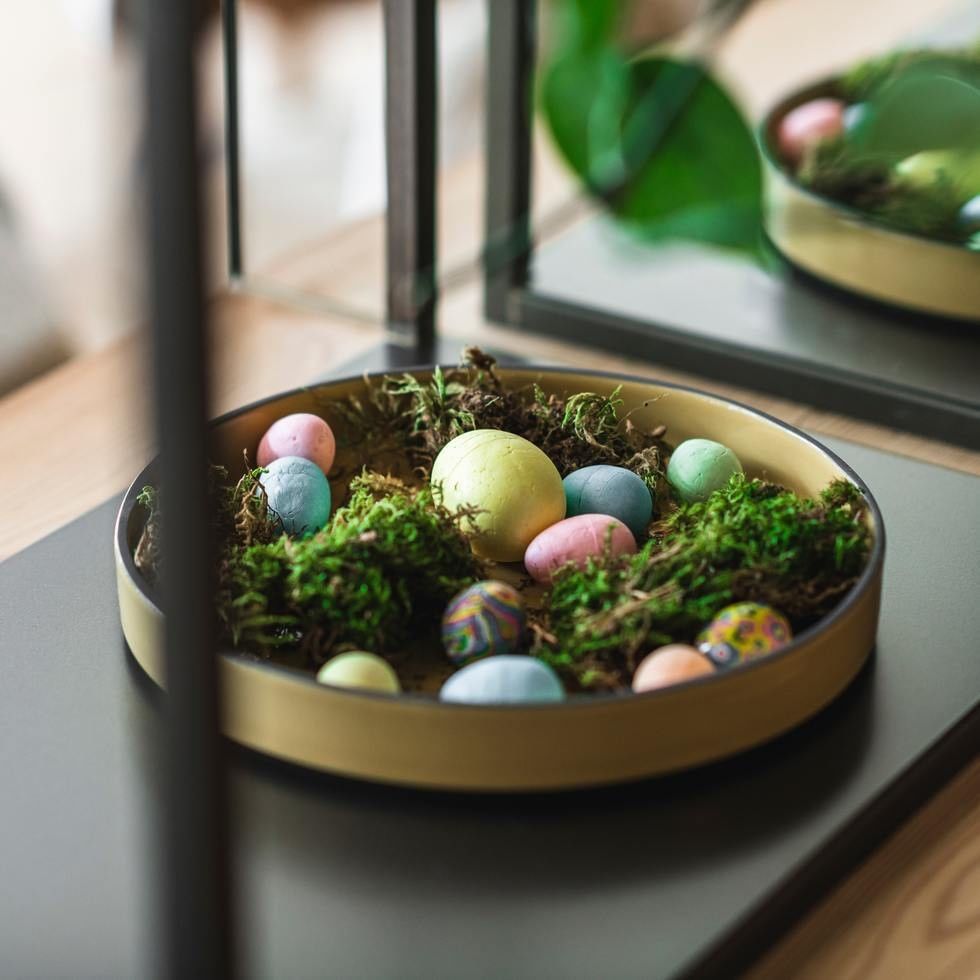 Decorative bowl filled with Easter eggs and moss for Family Time at Easter offer.