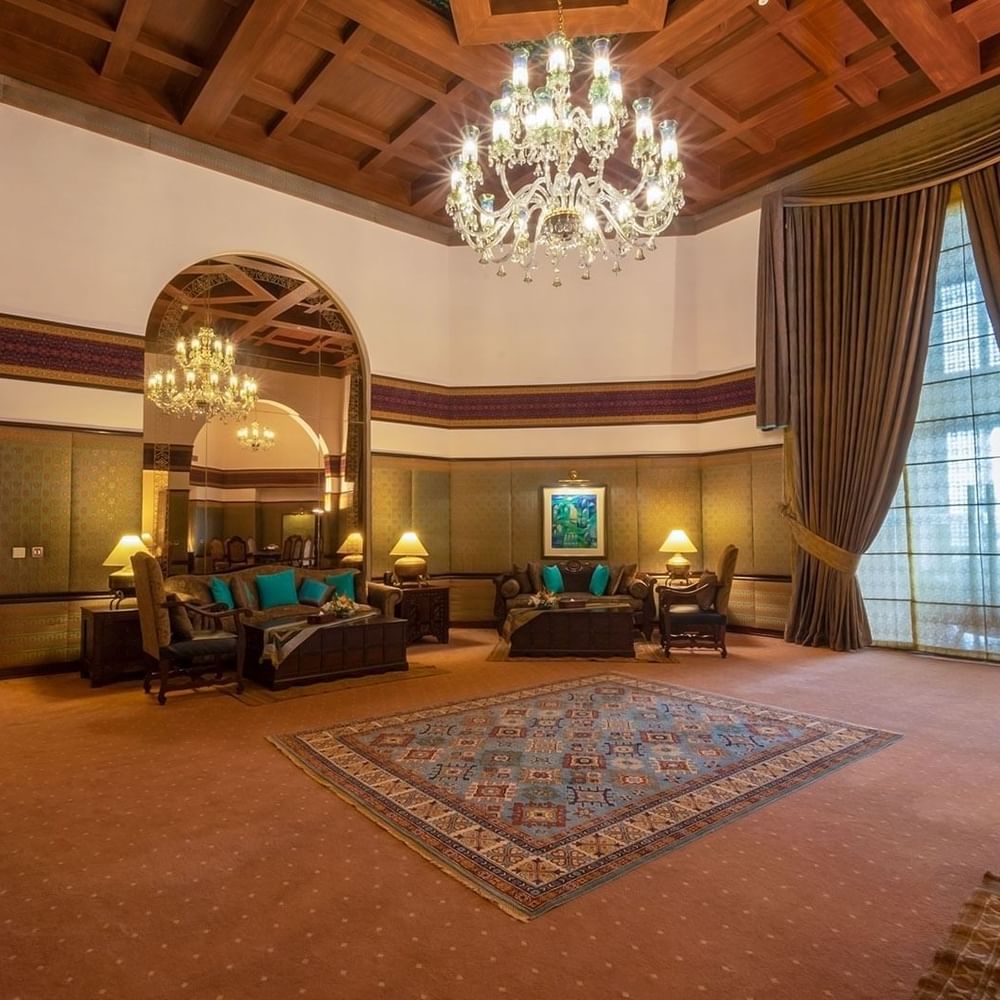 Elegantly furnished Presidential Suites with large rug and chandelier at Islamabad Serena Hotel in Islamabad.