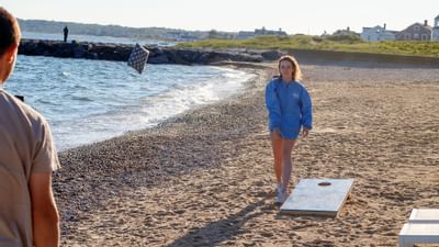 A couple playing games by the beach near Falmouth Tides