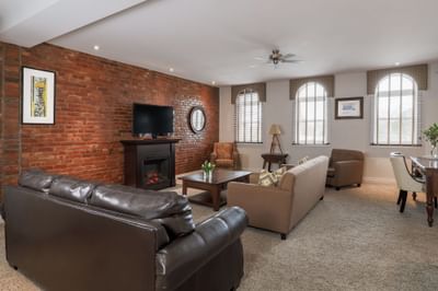 TV lounge area with cozy sofa & workspace in Executive Residences 201 at Retro Suites Hotel