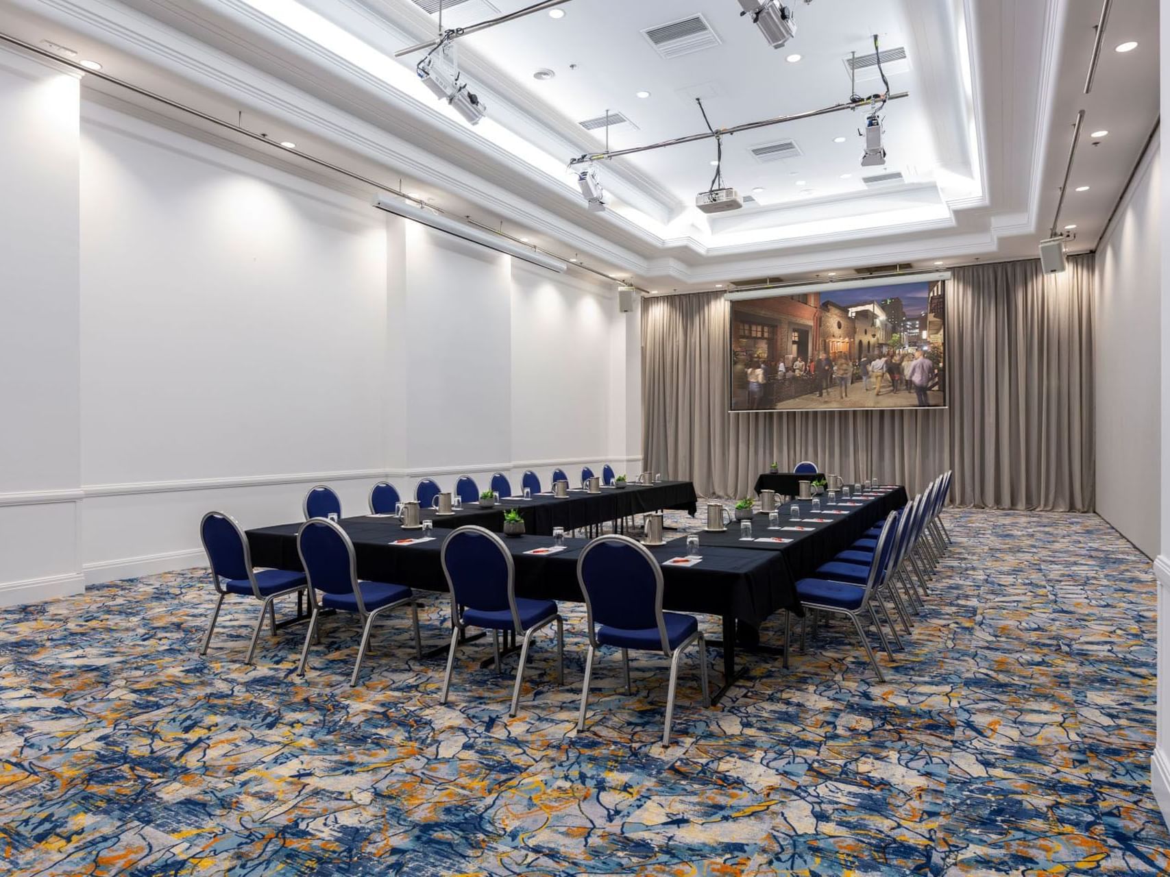 U-shape table set-up with a projector in Hindley 1 at Hotel Grand Chancellor Adelaide