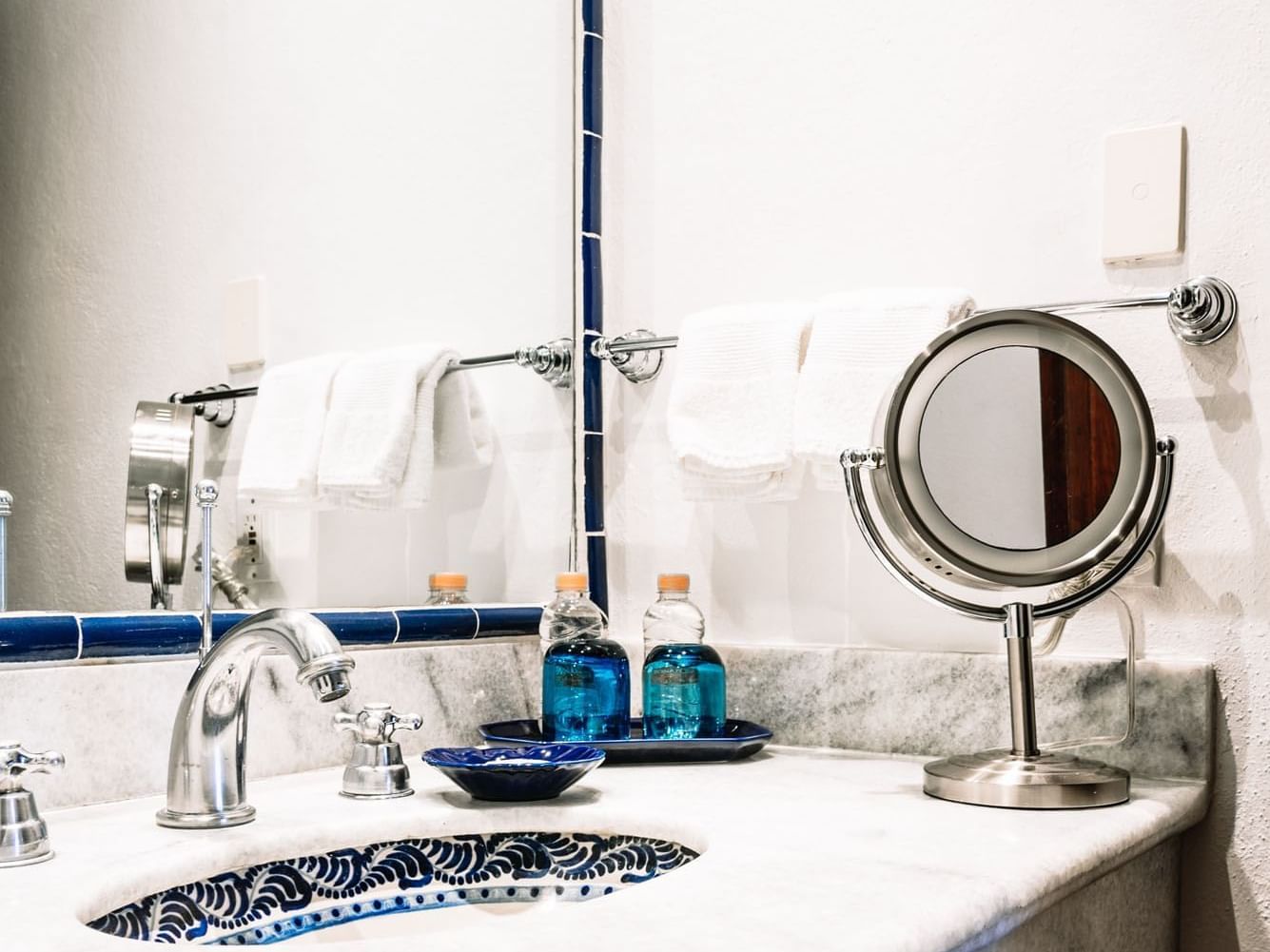 Bathroom counter with a large mirror and amenities in the King Governor Suite at Quinta Real Oaxaca
