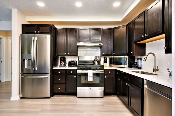 ADA room with modern kitchen with stainless steel appliances and dark cabinets at Vista Cay Resort By Millenium