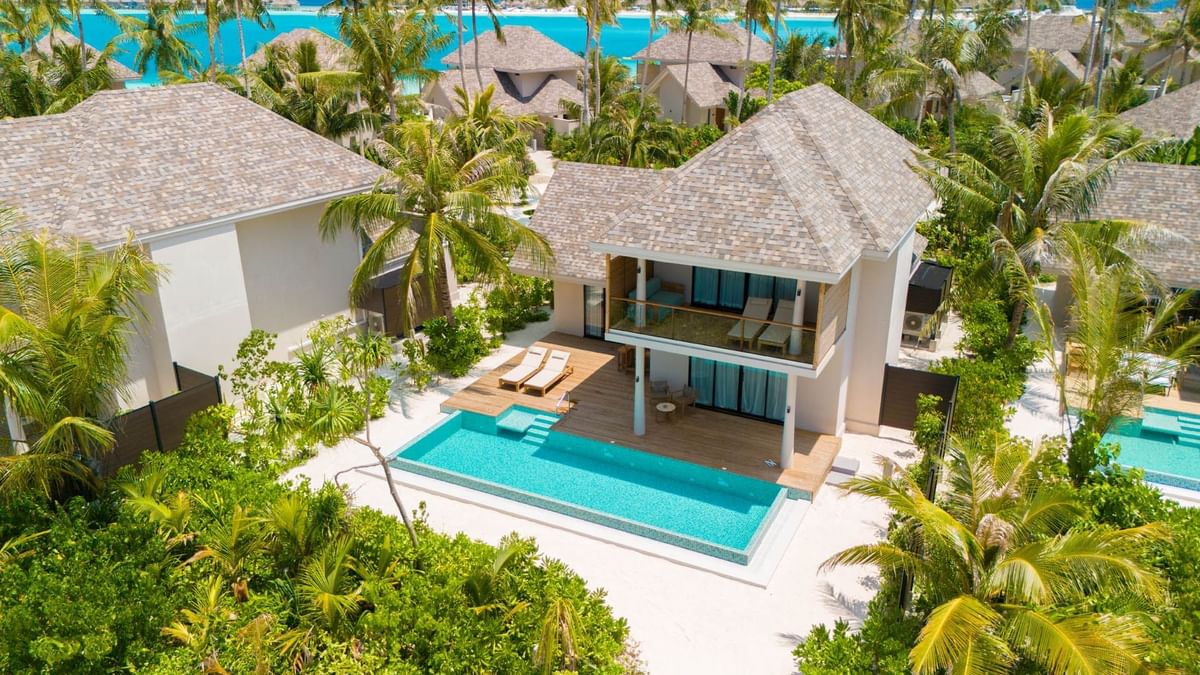 Aerial view of 2-Bedroom Beach Villas with pool area & sun loungers, surrounded by lush greenery at Ananea Madivaru Maldives