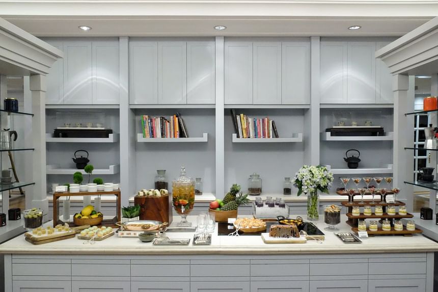Elegant dessert display featuring floral arrangements, layered parfaits, pastries, and colorful treats at Park Hyatt Saigon