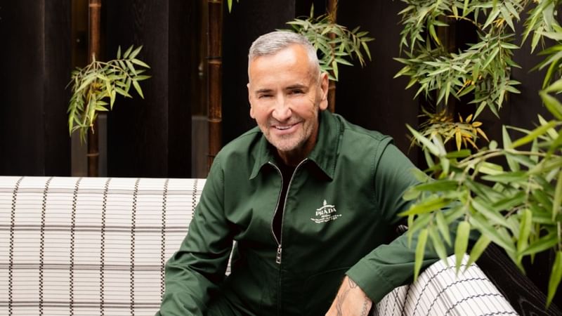 Fat Tony smiling on a couch sitting in the Shima garden in 8 at The Londoner.