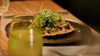 A sophisticated contemporary dinner entree paired elegantly with a signature beverage.
