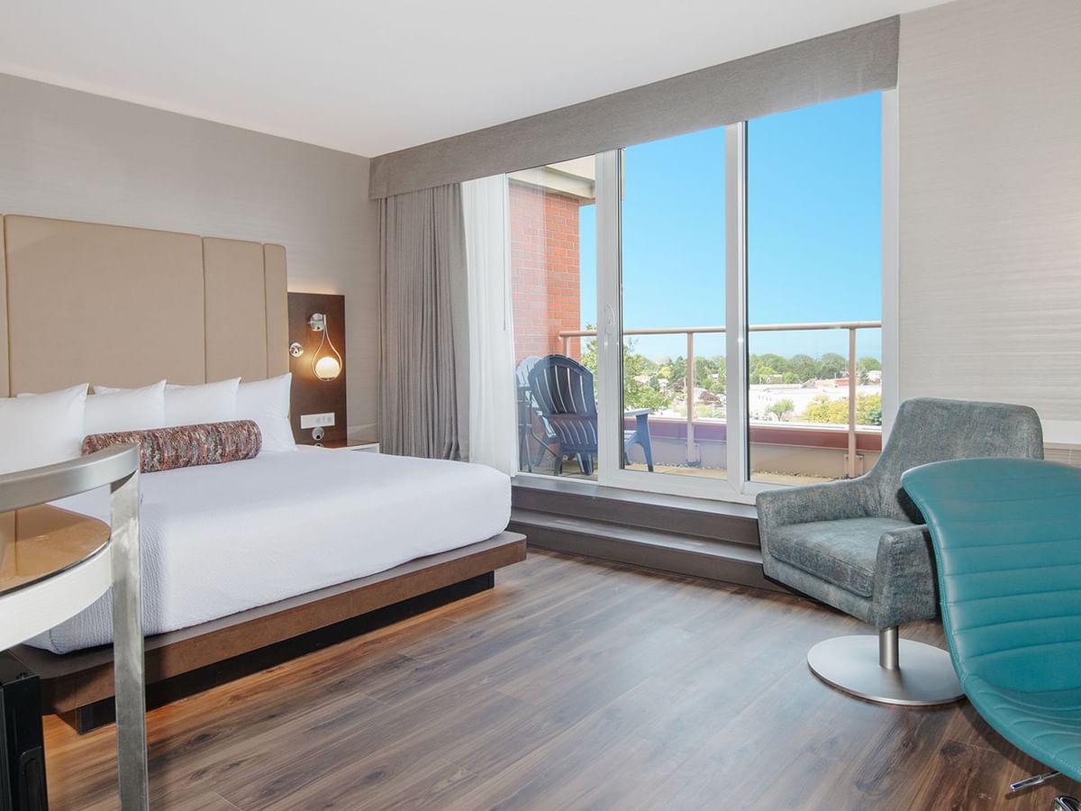 Hotel guestroom with a king size bed and balcony