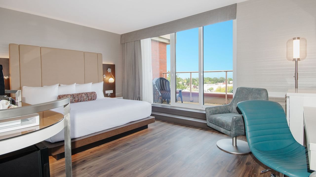 Hotel guestroom with a king size bed and balcony