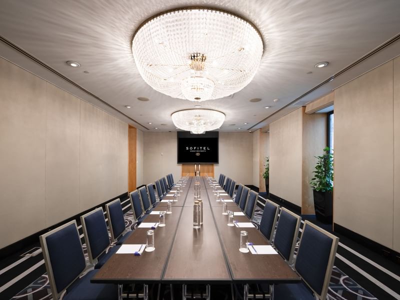 Canberra room executive meeting space with formal table setup and elegant lighting fixtures