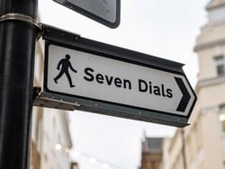 Close up on Seven Dials Central road sign near St. Giles Hotel