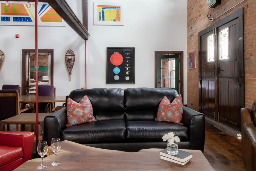Black sofa & coffee table in a lounge area at Retro Suites Hotel