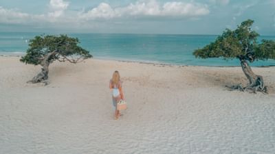 Young girl walking by the beach near Amsterdam Manor Resort