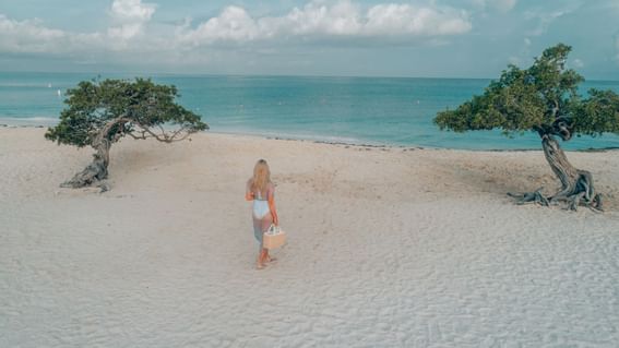 Young girl walking by the beach near Amsterdam Manor Resort