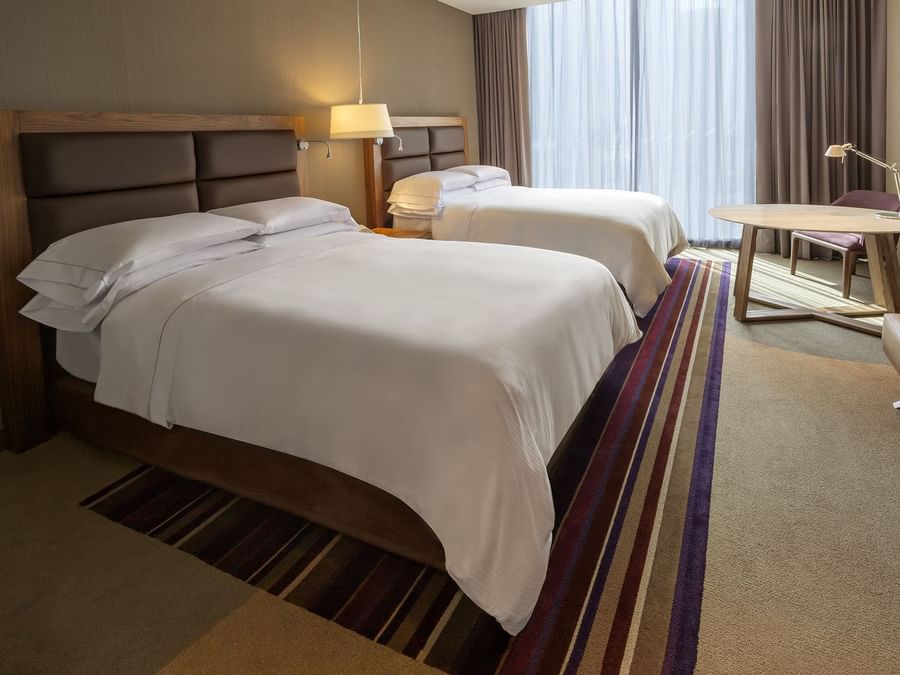 Deluxe room with double beds and small table