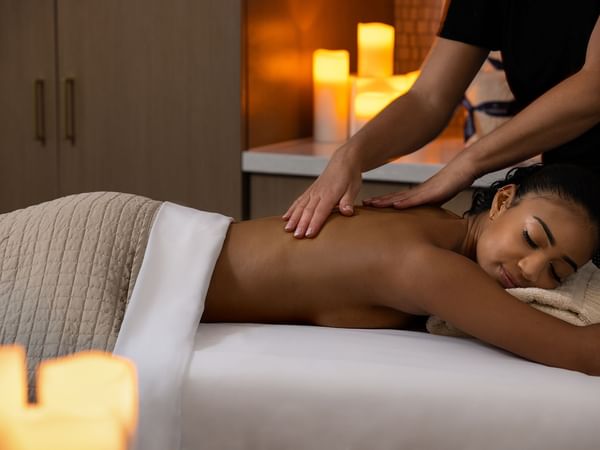 A lady receiving a back massage in Le Spa at Warwick Melrose