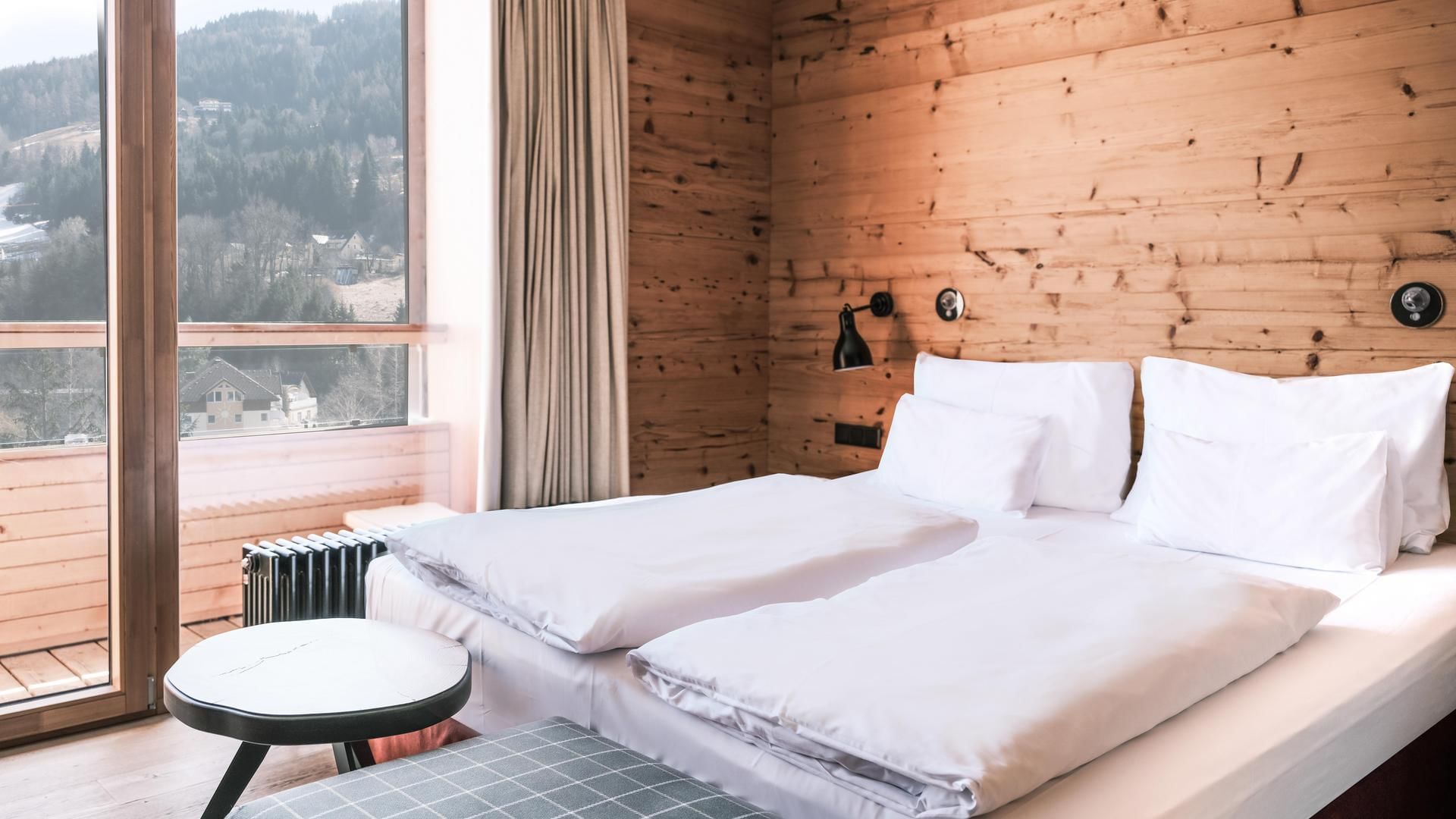 Large bed & mountain view Superior Room at Falkensteiner Hotels