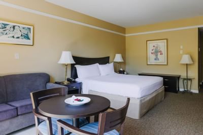 Large bed & table in Lagoon Room at Dinah's Garden Hotel