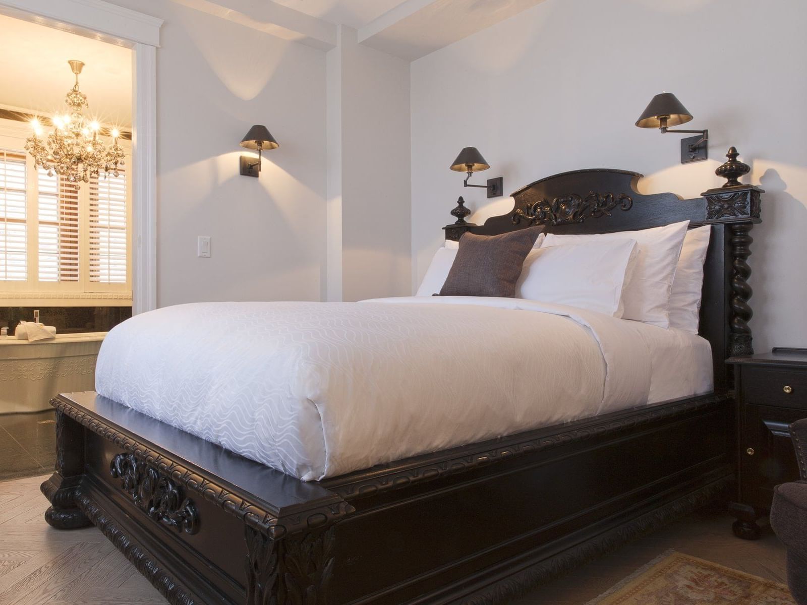 Nightstand by the queen bed in The Samuel-de-Champlain Room at Hotel Port Royal