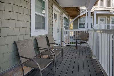 Cozy porch with four metal chairs at South Beach Apartments, featuring Ocean City Hotel deals