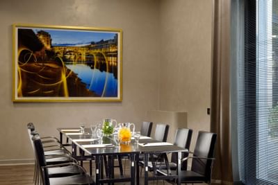 Dining table with a wall art at Grand Hotel Minerva