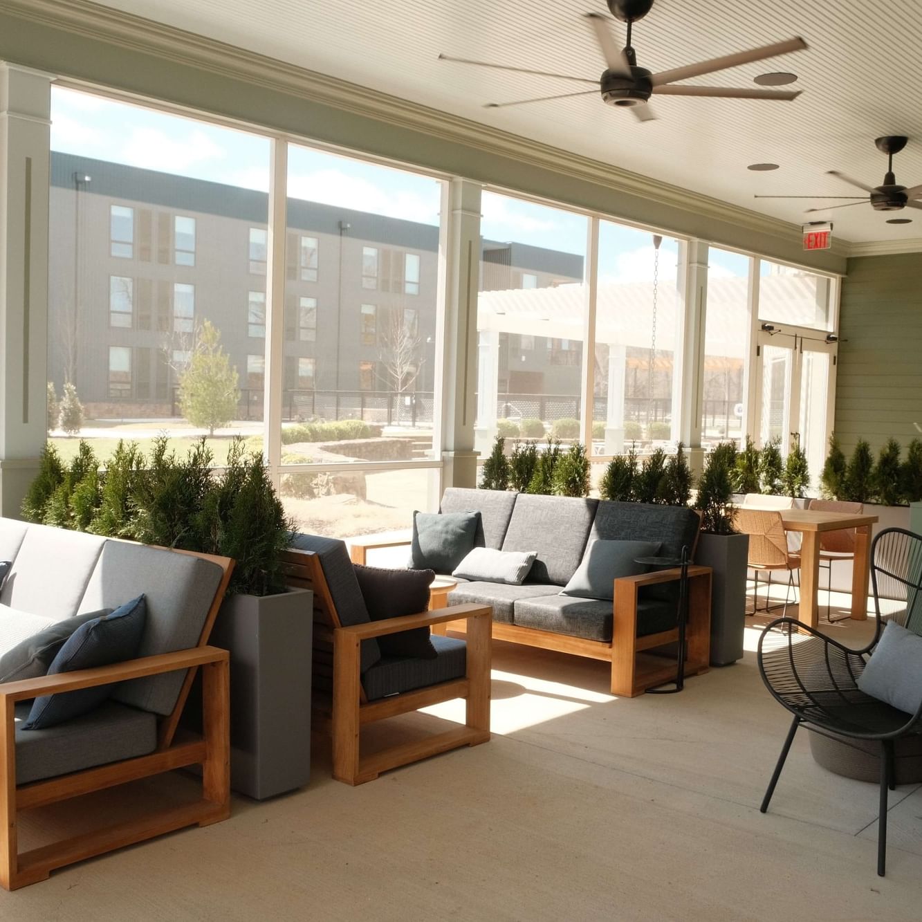 Modern vinyl patio lounge with comfortable seating and potted plants.
