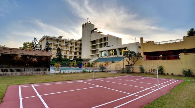 Tennis court with exterior of Peshawar Serena Hotel