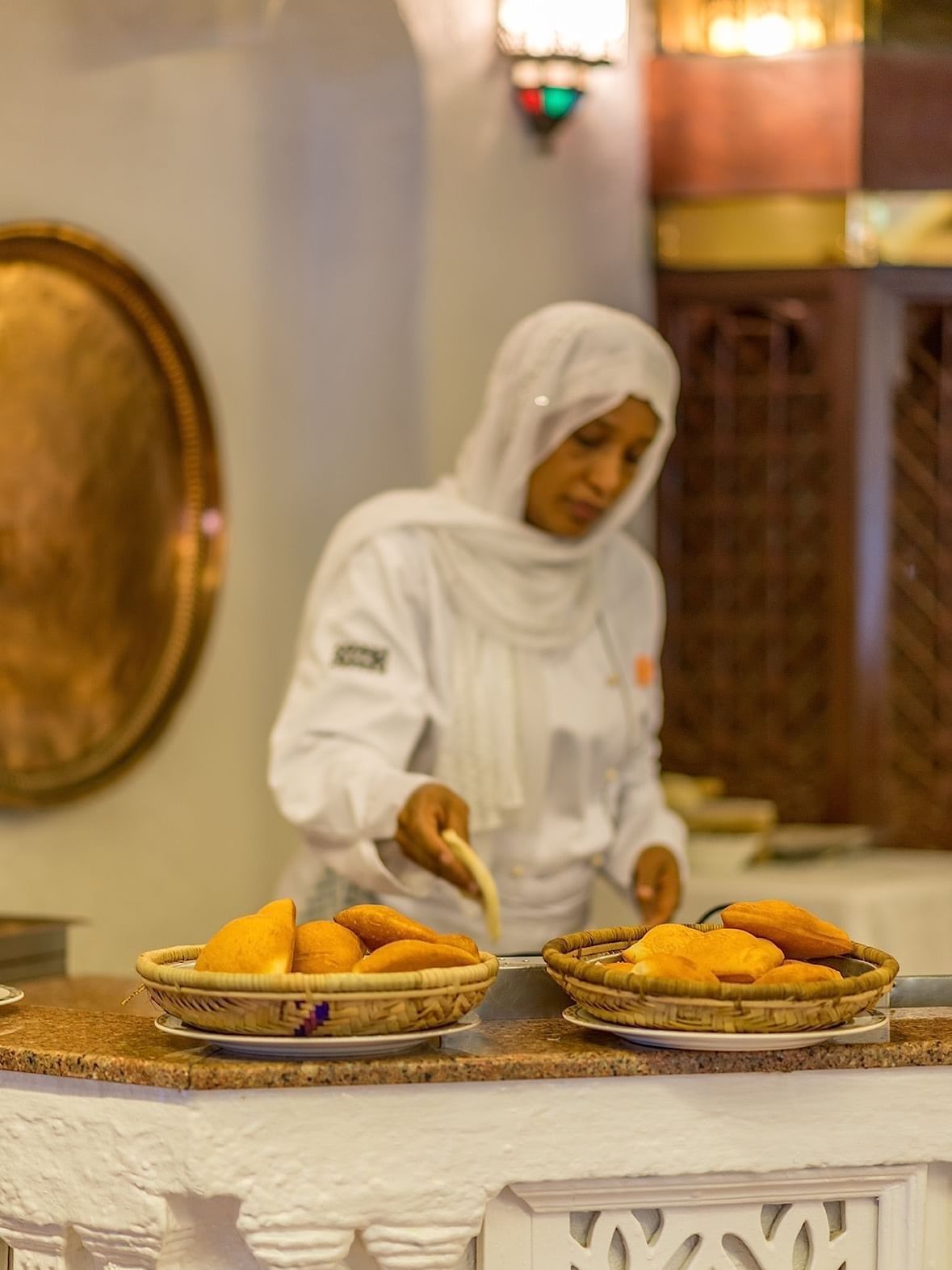 A chef preparing room service food in a basket at Serena Beach Resort & Spa in Mombasa.